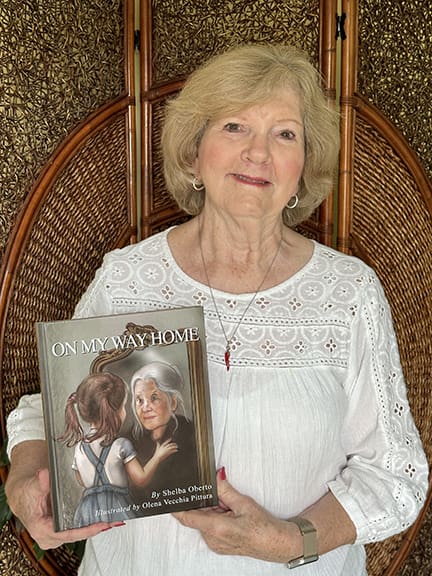 Author Shelba Oberto holds her latest picture book, On My Way Home