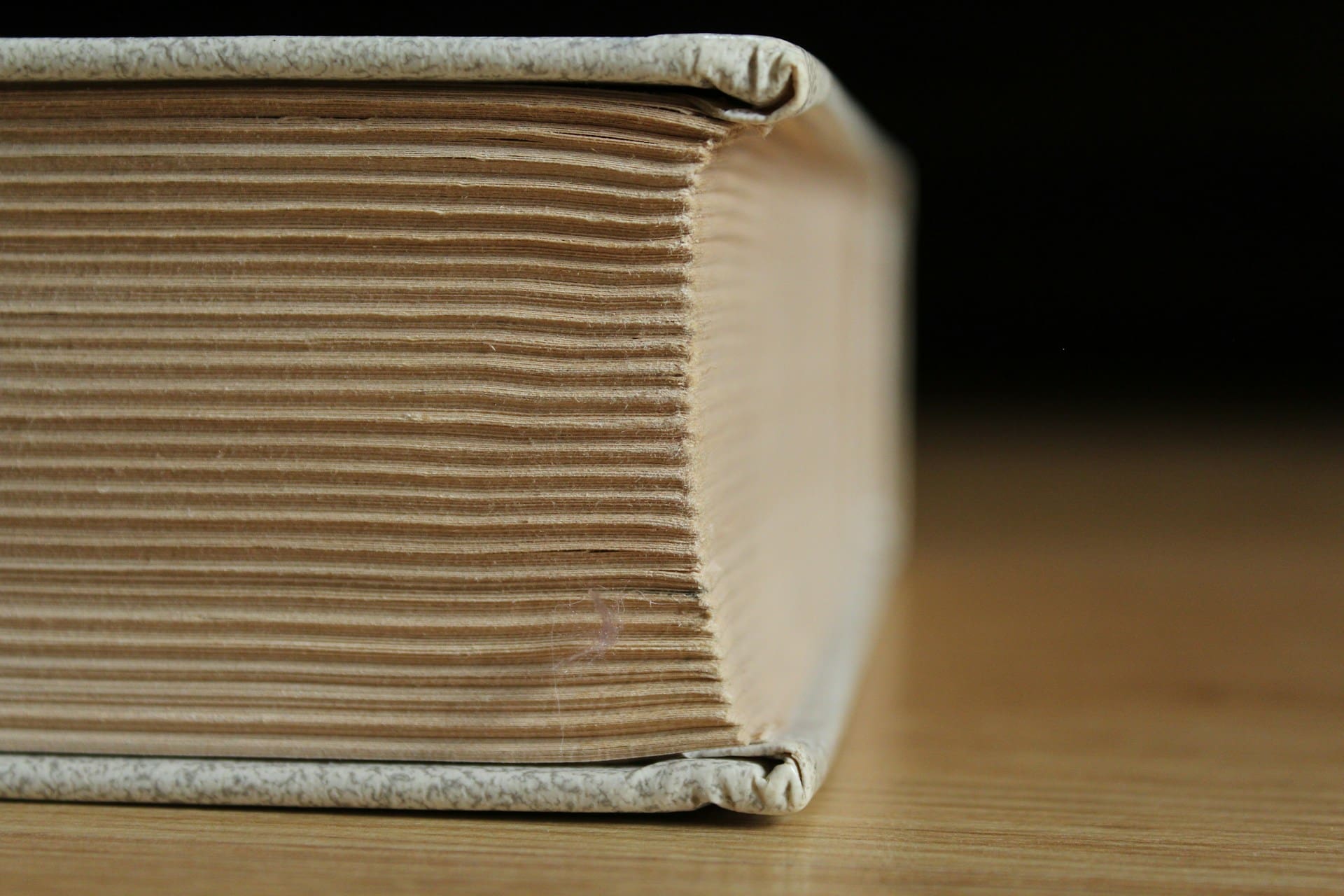 Thick book lying on its side, illustrating the topic, How long should your book be?