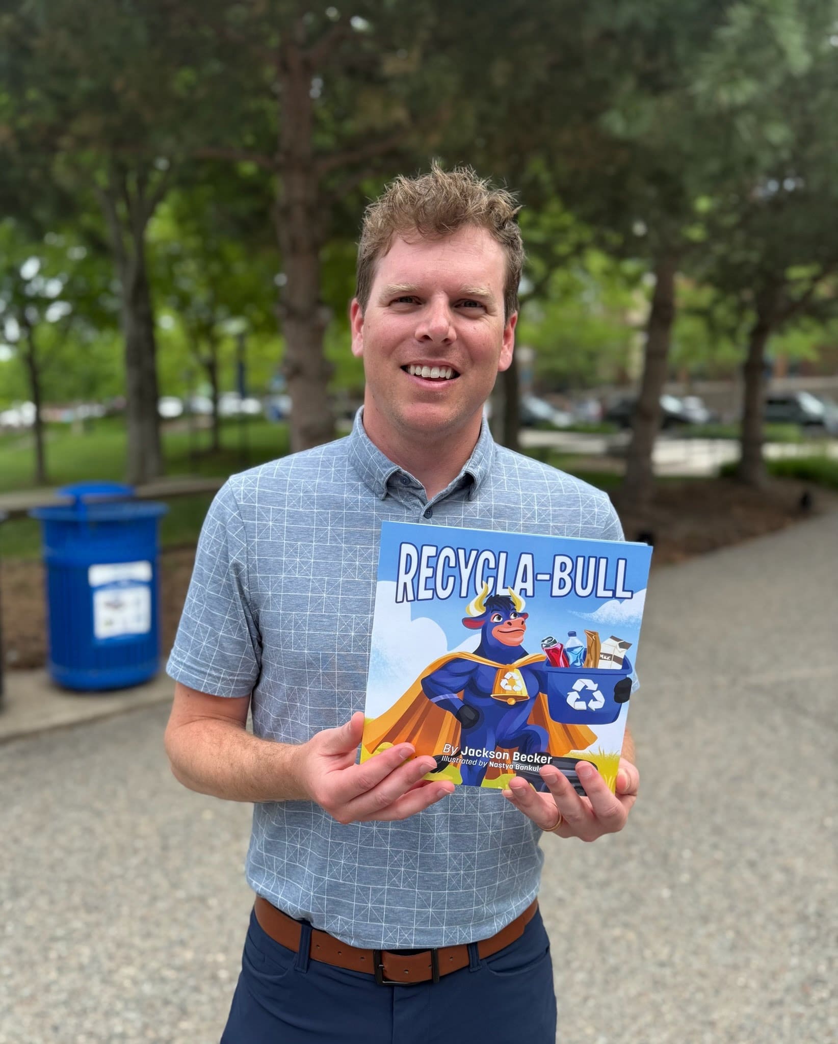 First-time picture book author Jackson Becker holds his children's book, Recycla-Bull, a book that teaches kids the value of recycling.
