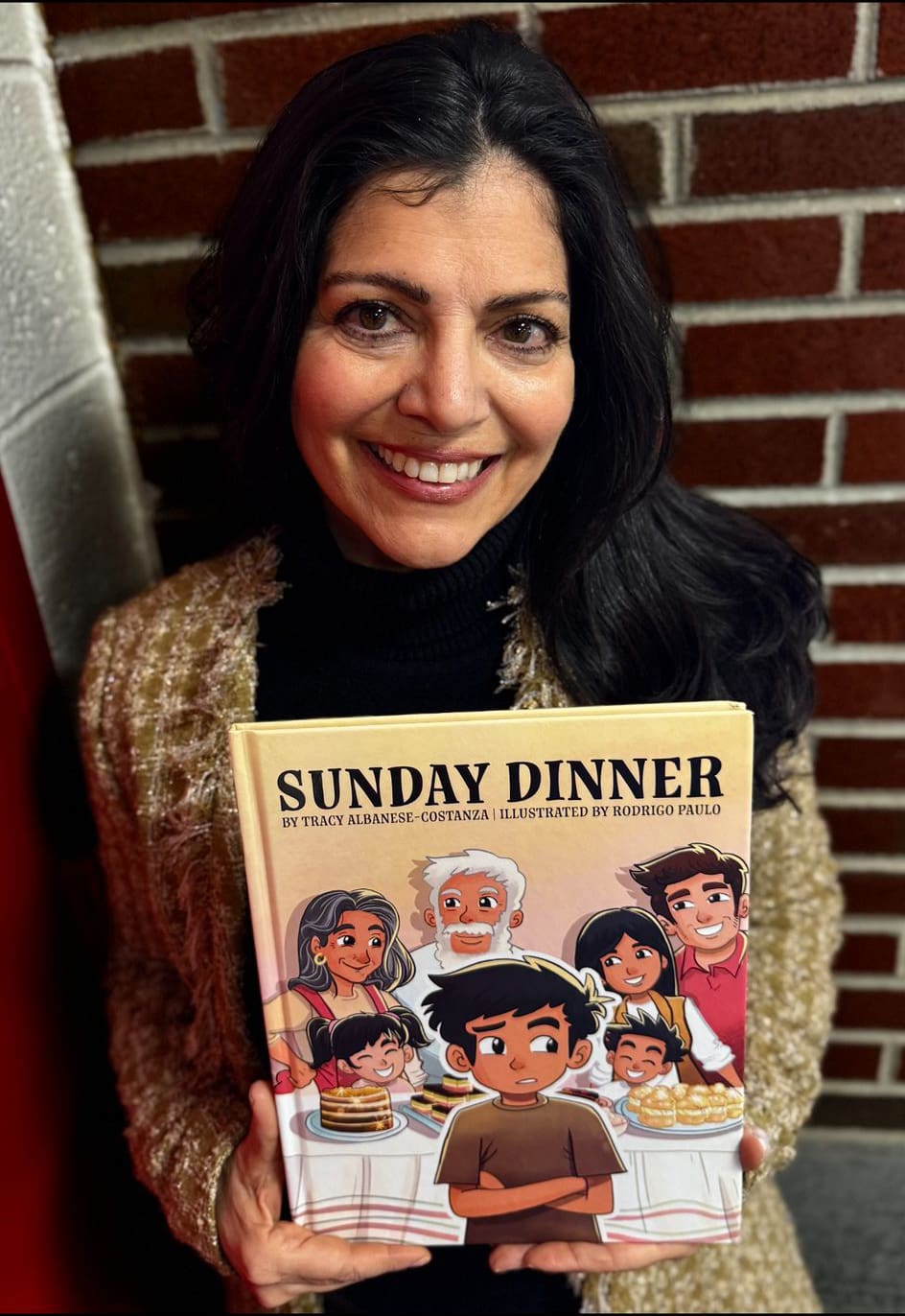 Image shows picture book author Tracy Albanese-Costanza with her first children's book, Sunday Dinner